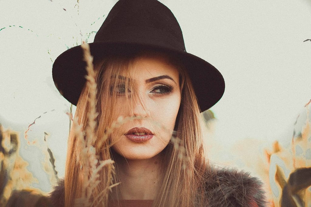A beautiful girl in a field. Image is discussing overcoming limiting beliefs by clearing abundance blocks